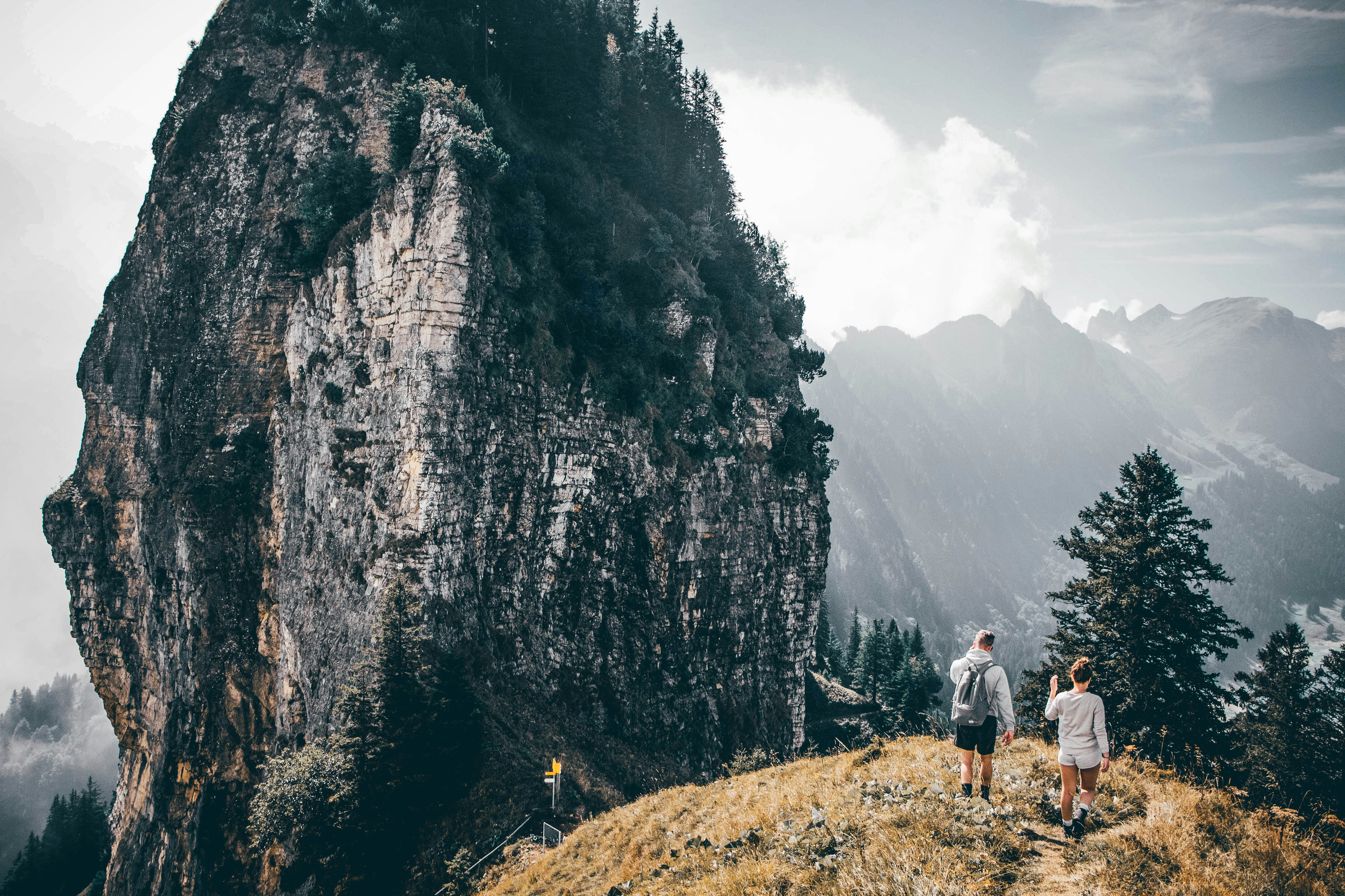 two person standing on mountain during daytime